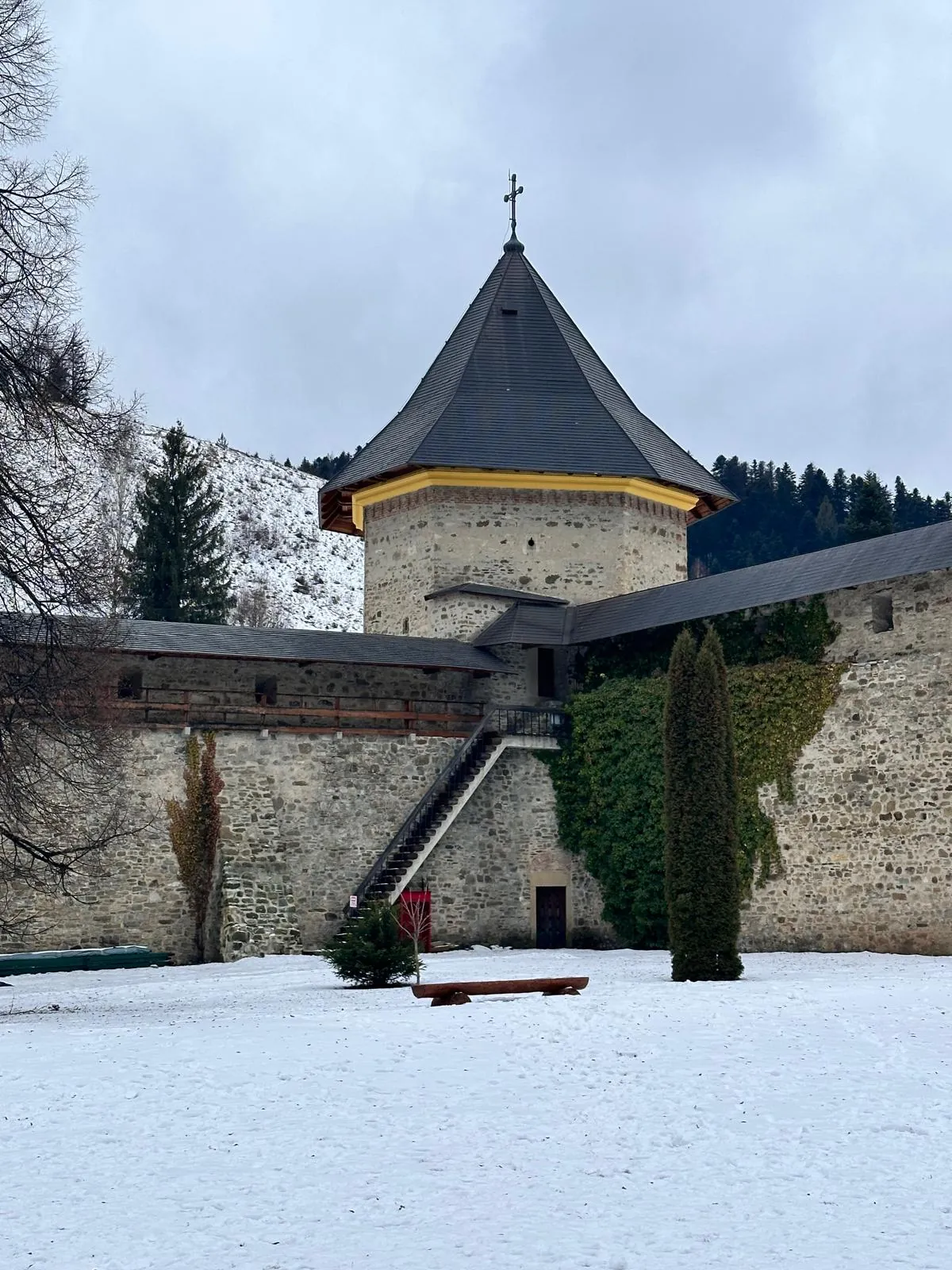 The fortress walls of Sucevița Monastery, with the corner tower, in winter